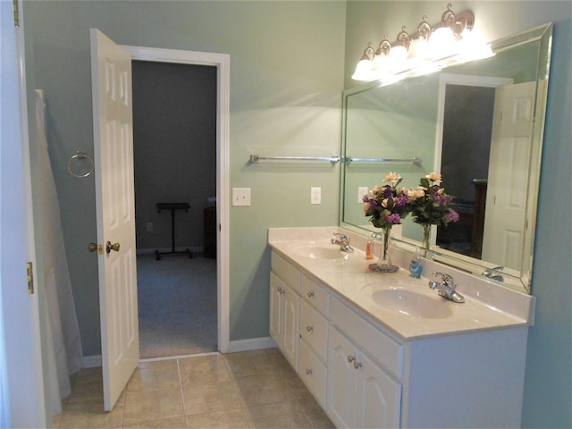 bathroom featuring double sink, tile flooring, and vanity with extensive cabinet space