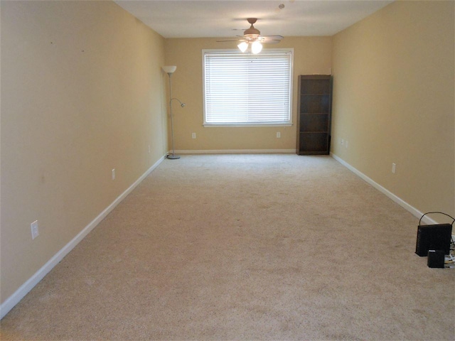 spare room with light carpet and ceiling fan