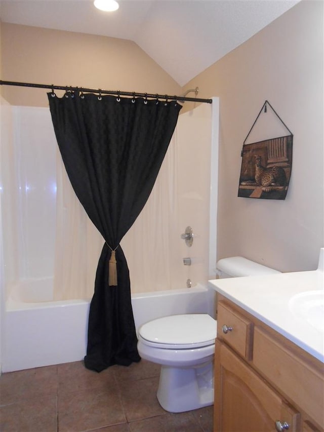 full bathroom featuring shower / bath combination with curtain, tile floors, vaulted ceiling, vanity, and toilet