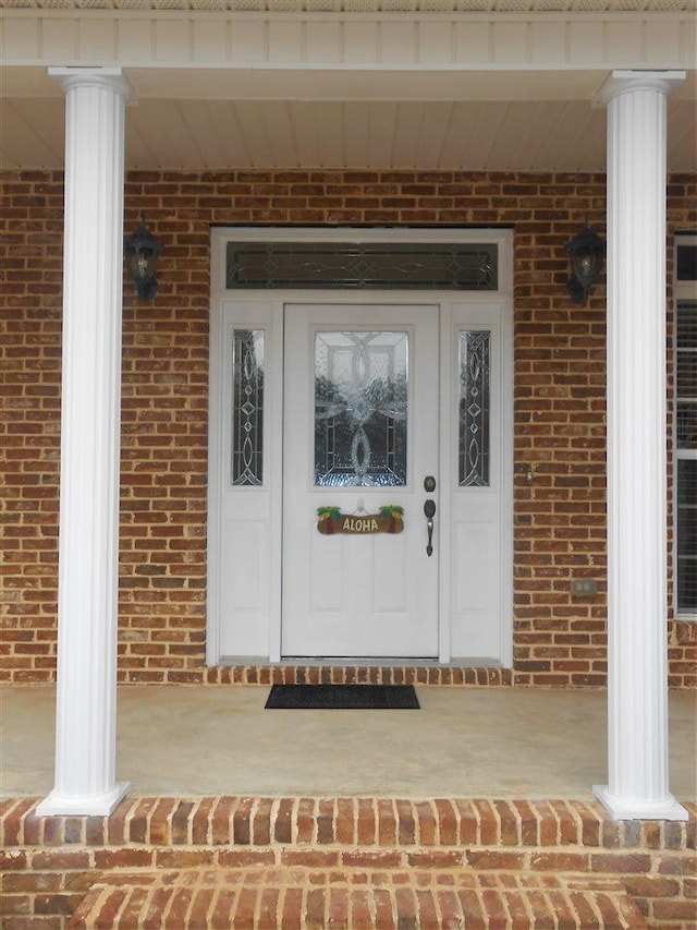 view of exterior entry featuring a porch