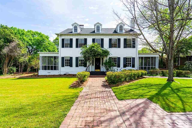 colonial-style house with a front lawn