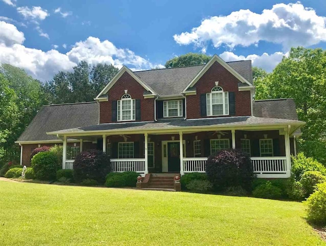 colonial-style house with covered porch and a front yard