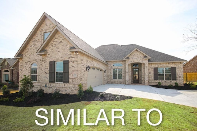 view of front of property featuring a front lawn and a garage