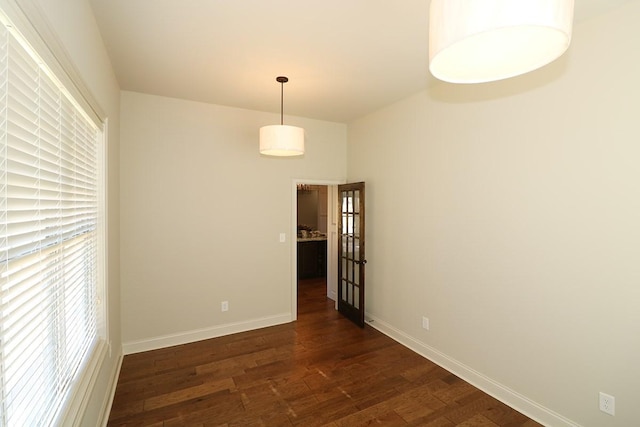 unfurnished room featuring dark hardwood / wood-style flooring