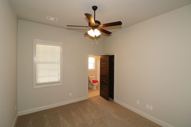 unfurnished room featuring dark carpet and ceiling fan