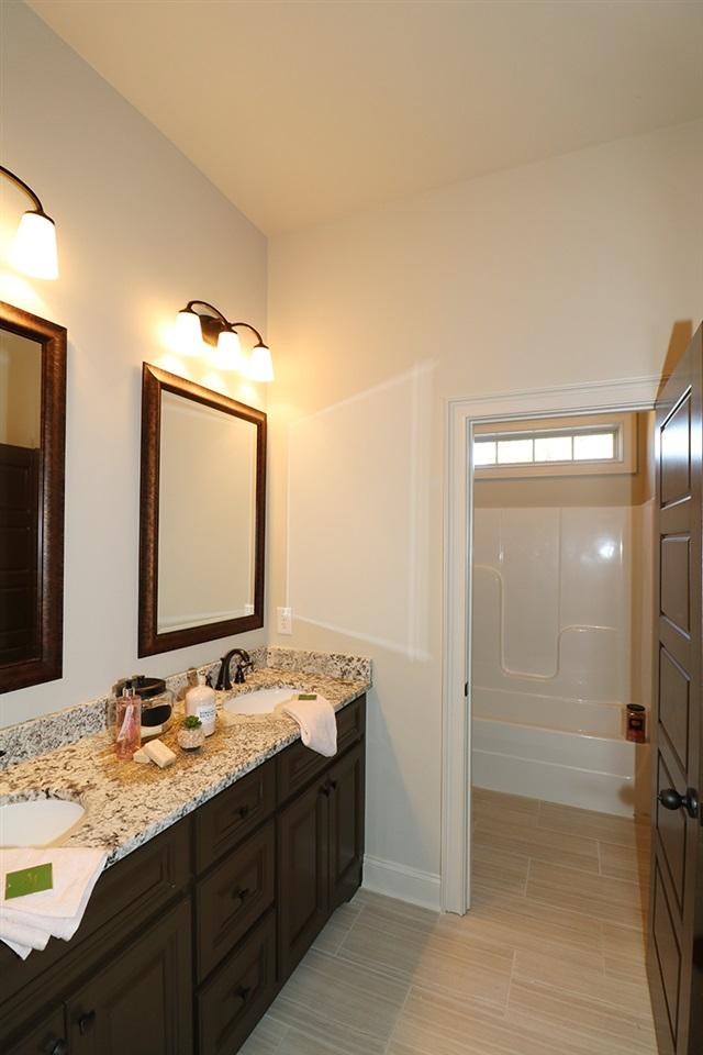 bathroom featuring tile flooring and double vanity