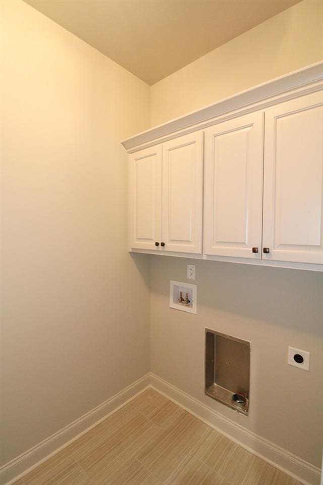 laundry area featuring washer hookup, cabinets, and hookup for an electric dryer