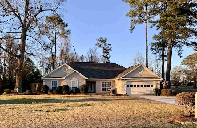 ranch-style home with a front lawn and a garage