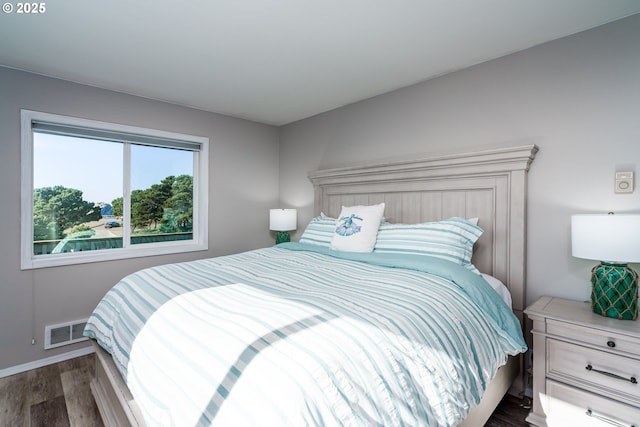 2131 Beach Loop Dr, Bandon, OR 97411 - bedroom featuring dark wood finished floors, visible vents, and baseboards