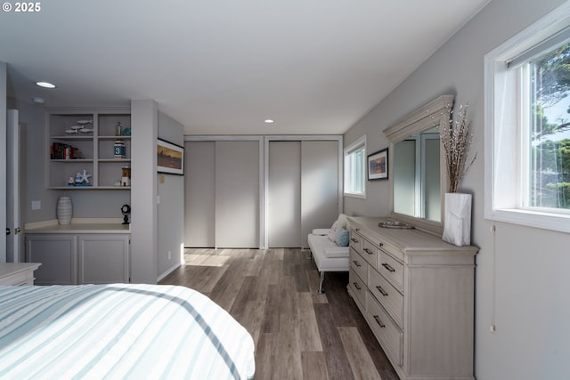 2131 Beach Loop Dr, Bandon, OR 97411 - bedroom featuring recessed lighting, multiple windows, multiple closets, and wood finished floors