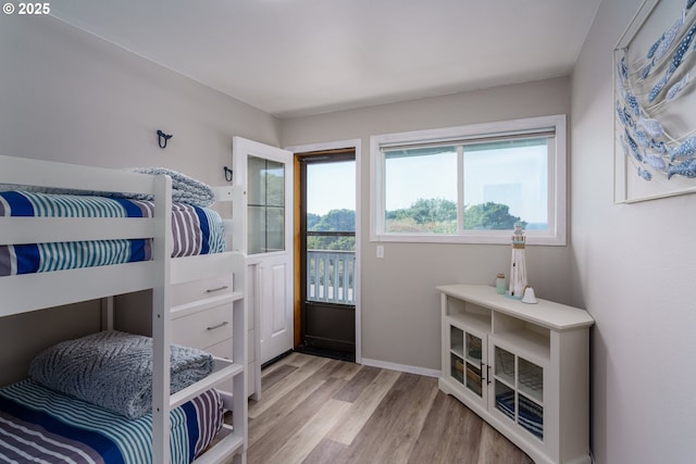 2131 Beach Loop Dr, Bandon, OR 97411 - bedroom with baseboards and wood finished floors