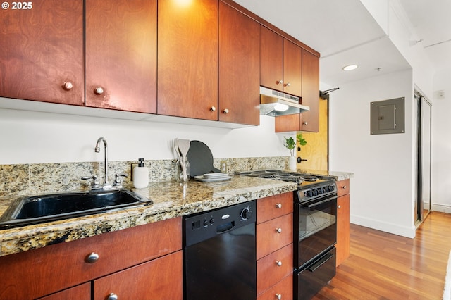 kitchen featuring under cabinet range hood, electric panel, light wood-style flooring, black appliances, and a sink