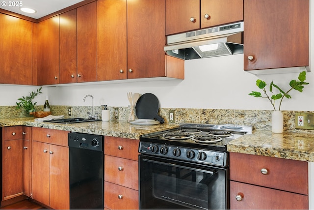 kitchen featuring under cabinet range hood, brown cabinets, black appliances, and a sink