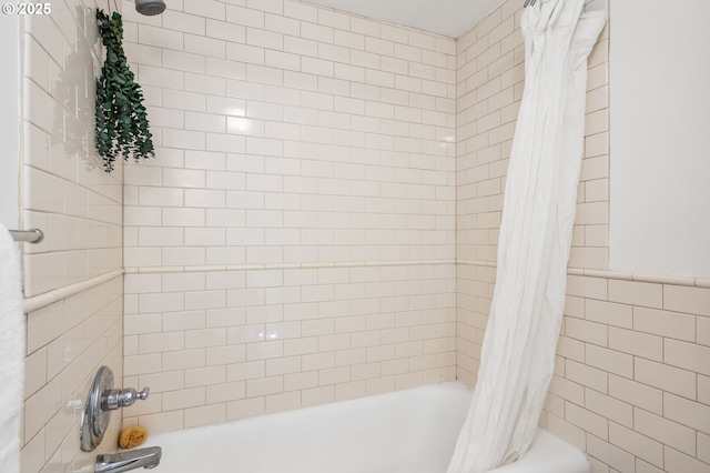 bathroom featuring tile walls and shower / bath combo