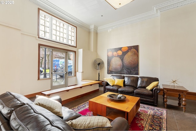 tiled living area featuring crown molding and baseboards