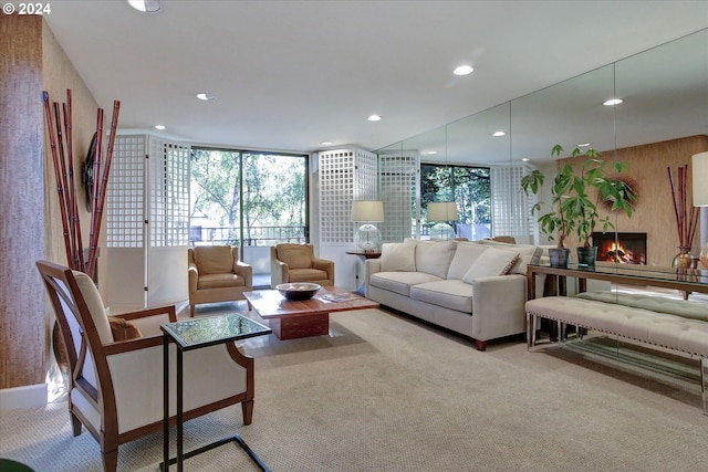 living room featuring light colored carpet and expansive windows