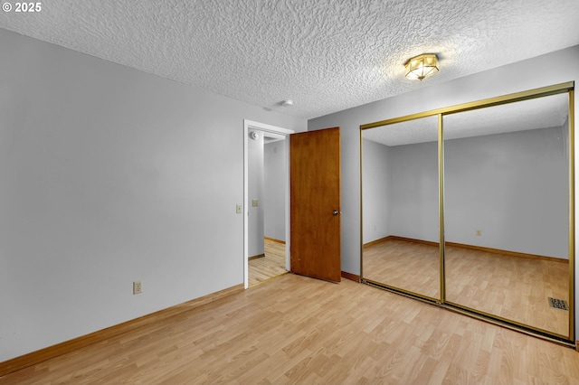602 SE 130th Ct, Vancouver, WA 98683 - unfurnished bedroom with wood finished floors, a textured ceiling, a closet, and baseboards