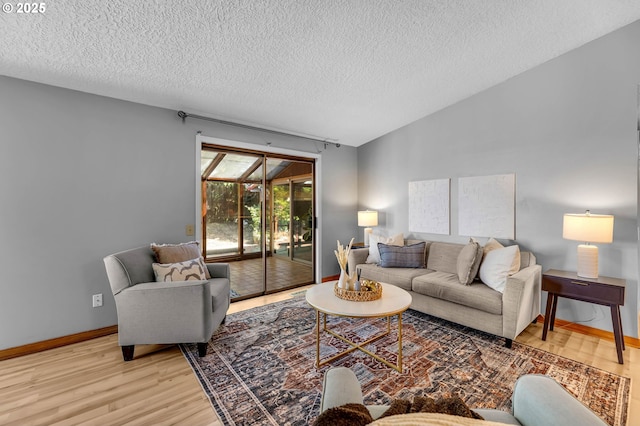 602 SE 130th Ct, Vancouver, WA 98683 - living room featuring light wood-style flooring, a textured ceiling, and baseboards