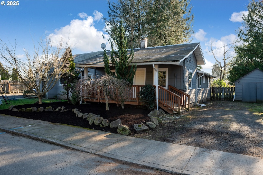 view of front of house featuring a storage unit