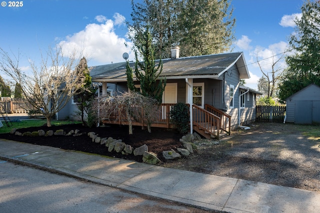 view of front of house featuring a storage unit