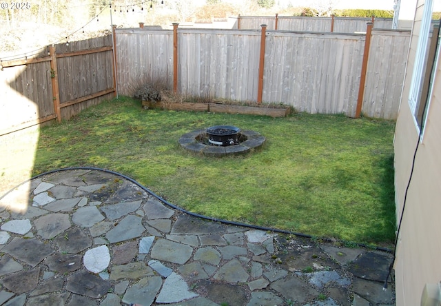 view of yard with an outdoor fire pit and a fenced backyard