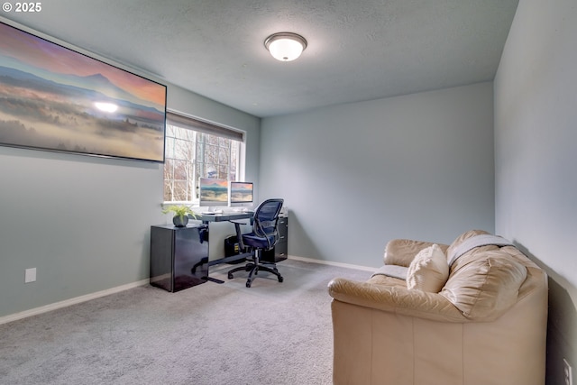 carpeted office space featuring a textured ceiling