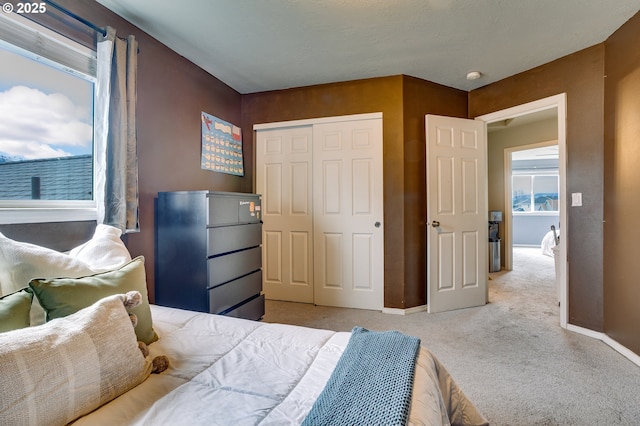 carpeted bedroom with a closet