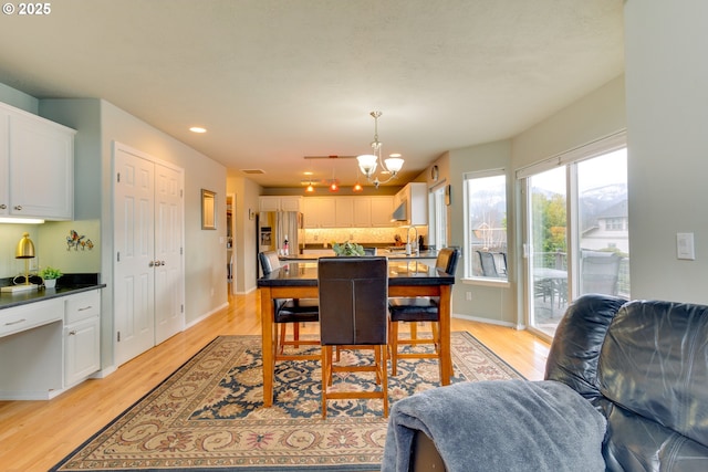 dining room featuring an inviting chandelier and light wood-type flooring