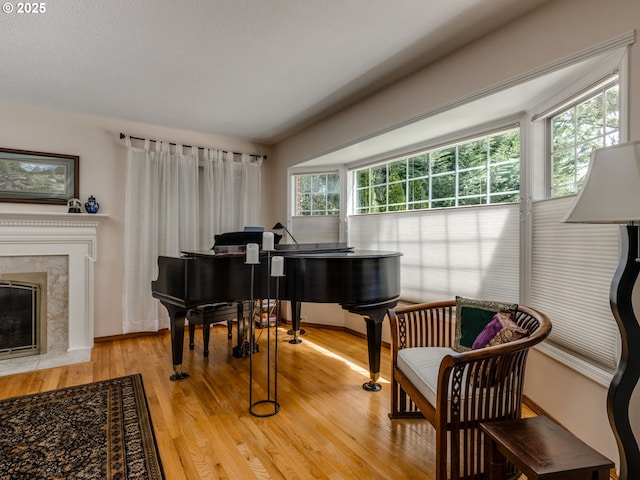 sitting room with light wood-style flooring and a high end fireplace