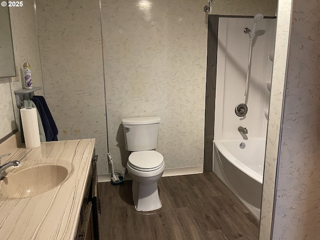 full bathroom with wood finished floors, toilet, vanity, and bathing tub / shower combination