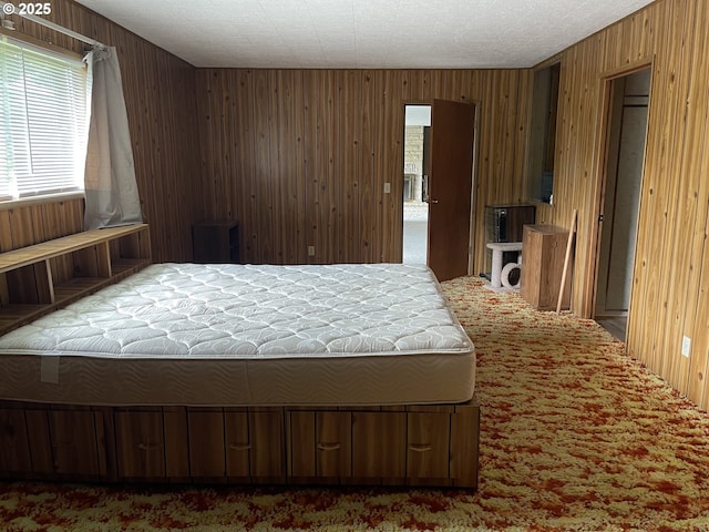bedroom with carpet flooring and wooden walls
