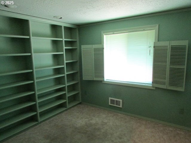 10285 S Rosewood Way, Molalla, OR 97038 - unfurnished bedroom featuring a textured ceiling and carpet floors