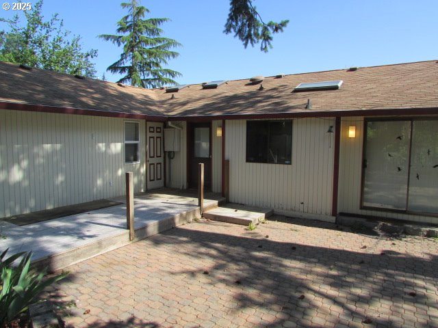 10285 S Rosewood Way, Molalla, OR 97038 - doorway to property with roof with shingles and a patio
