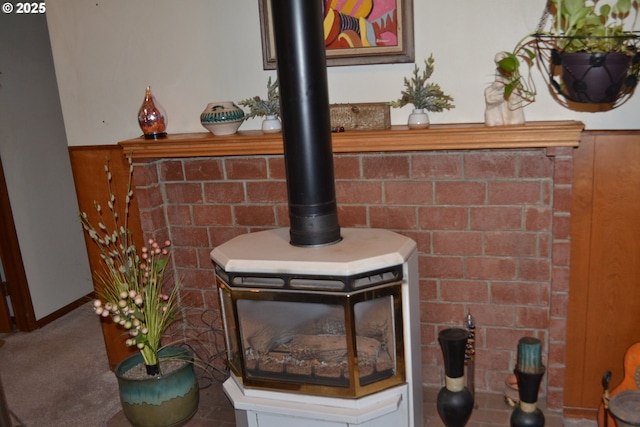 details with carpet and a wood stove