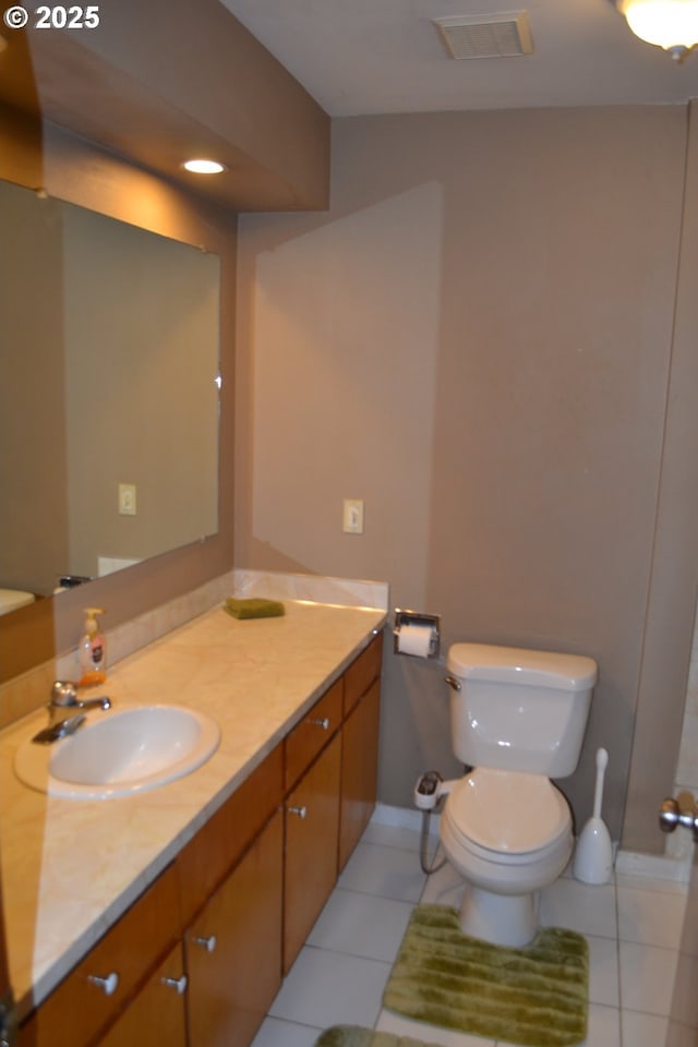 bathroom with vanity, tile patterned floors, and toilet