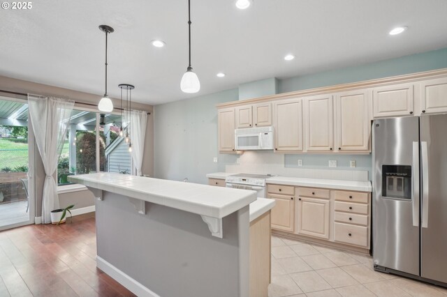 1705 SE 111th Ct, Vancouver, WA 98664 - kitchen featuring tile counters, recessed lighting, white appliances, baseboards, and pendant lighting