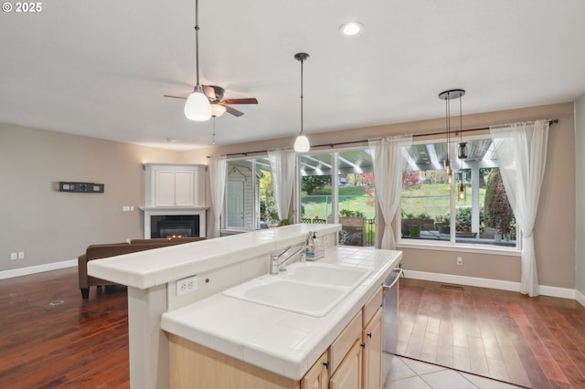 1705 SE 111th Ct, Vancouver, WA 98664 - kitchen with baseboards, dishwasher, tile countertops, and a sink