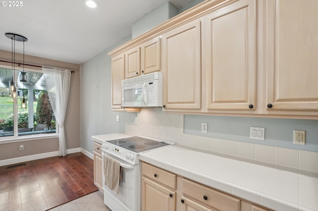 1705 SE 111th Ct, Vancouver, WA 98664 - kitchen with light brown cabinetry, baseboards, backsplash, white appliances, and tile counters