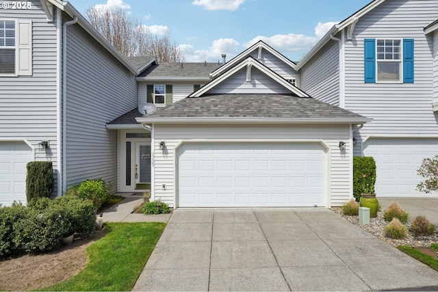 1705 SE 111th Ct, Vancouver, WA 98664 - view of front facade featuring a garage, driveway, and a shingled roof