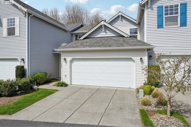 1705 SE 111th Ct, Vancouver, WA 98664 - view of front facade featuring an attached garage, driveway, and roof with shingles