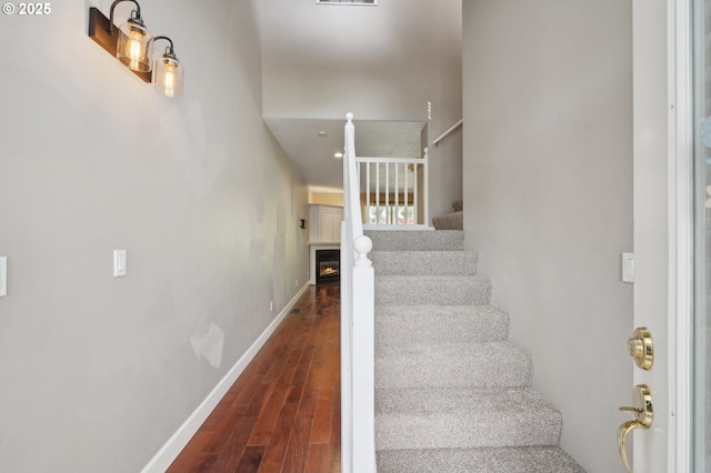 1705 SE 111th Ct, Vancouver, WA 98664 - staircase featuring a warm lit fireplace, wood finished floors, visible vents, and baseboards