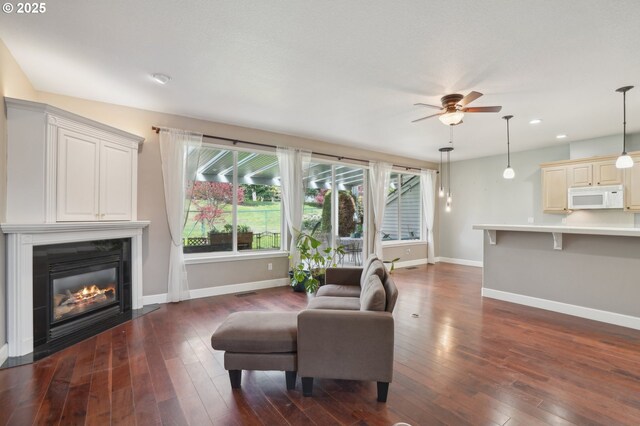 1705 SE 111th Ct, Vancouver, WA 98664 - living room featuring a fireplace with flush hearth, recessed lighting, dark wood-style floors, baseboards, and ceiling fan