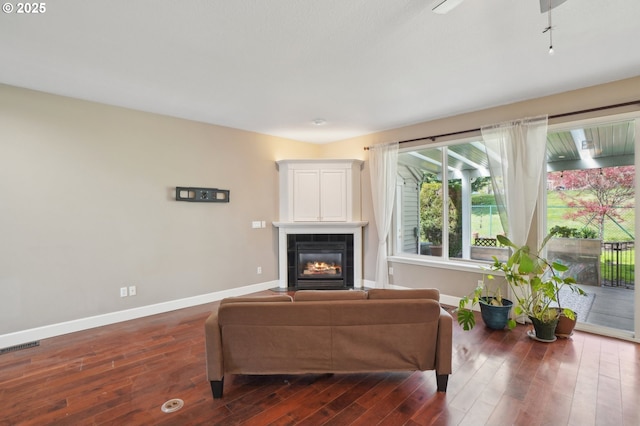 1705 SE 111th Ct, Vancouver, WA 98664 - living area featuring a tiled fireplace, visible vents, baseboards, and dark wood-style flooring