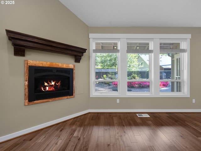 64911 E Mountain Meadow Ln, Rhododendron, OR 97049 - unfurnished living room with baseboards, wood finished floors, and a lit fireplace