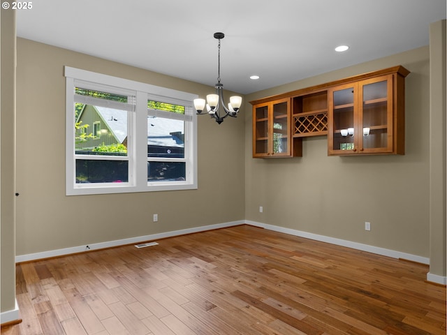 64911 E Mountain Meadow Ln, Rhododendron, OR 97049 - spare room with a chandelier, wood finished floors, baseboards, and recessed lighting