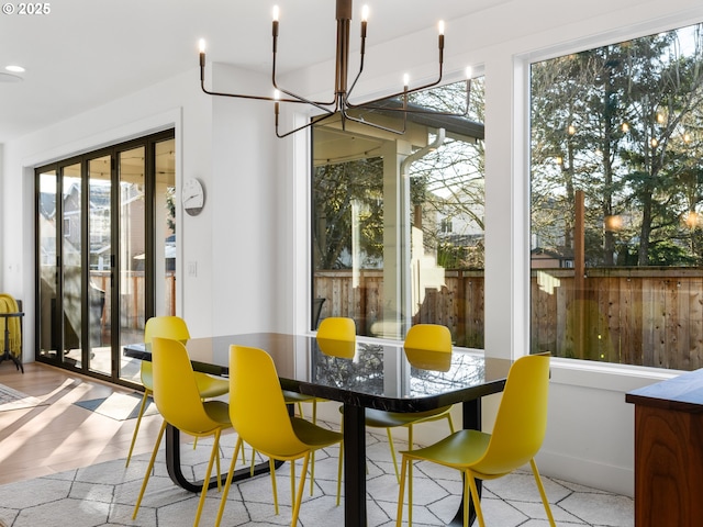 dining room with a notable chandelier and light hardwood / wood-style floors