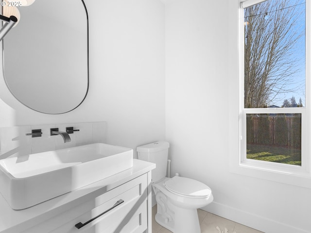 bathroom featuring tile patterned flooring, vanity, and toilet