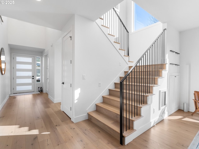 stairs with hardwood / wood-style flooring