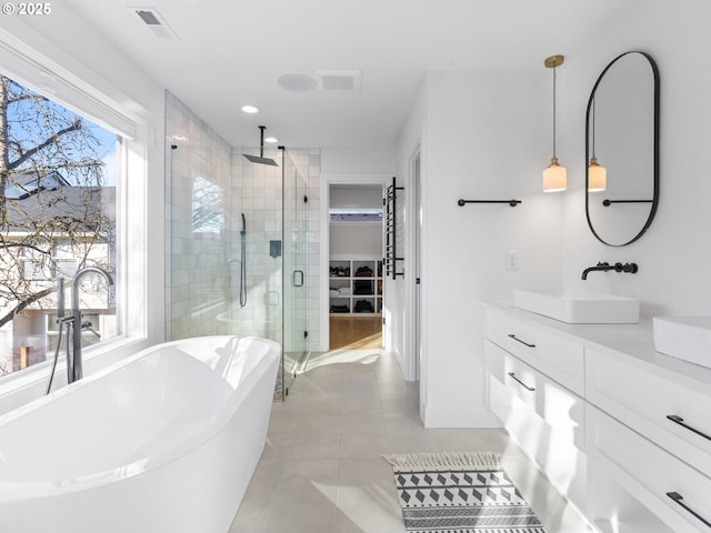 bathroom with tile patterned flooring, shower with separate bathtub, and vanity