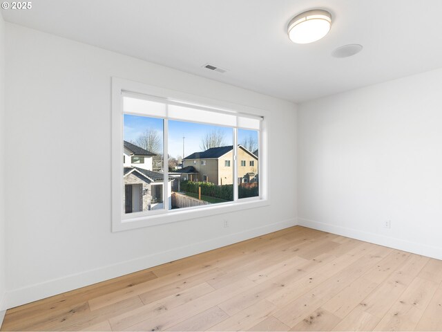 spare room with light hardwood / wood-style floors